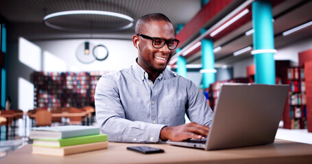 Male Student Studying With Computer Doing Research