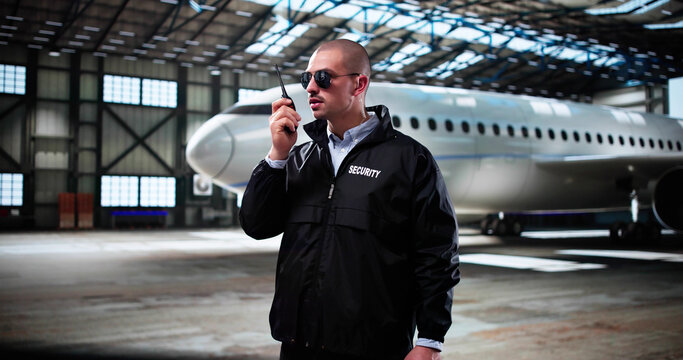 Guard Security Man In Airplane Hangar