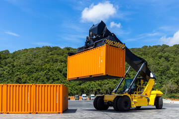 Reach stacker cargo forklift container box import export logistic transportation industrial, Reach stacker pick up container, Reach stacker container loader crane lifting maritime cargo container. © Kalyakan