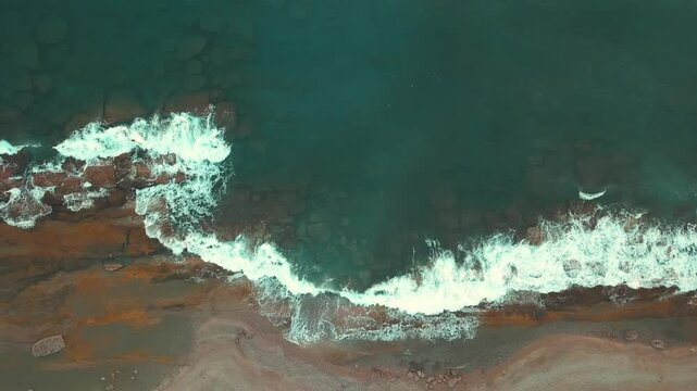 Aerial View of Waves Crashing Against the Shore at Koru Beach in Gazipasa, Turkey, Captured in Soft Sunset Light, Serene Coastal Scene in the Mediterranean