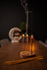 Incense sticks smoldering on table indoors, space for text