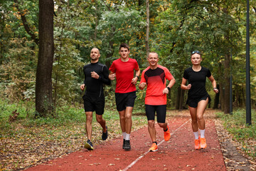 Group of people jogging together in park