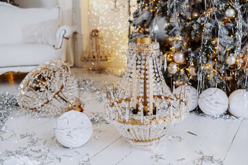 Elegant Christmas decorations with chandelier and festive ornaments by a tree