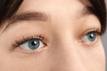 Fototapeta premium Closeup view of young woman with beautiful blue eyes