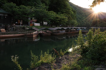 Naklejka premium Japan Travel: Scenic River with Boat and Beautiful Natural Surroundings