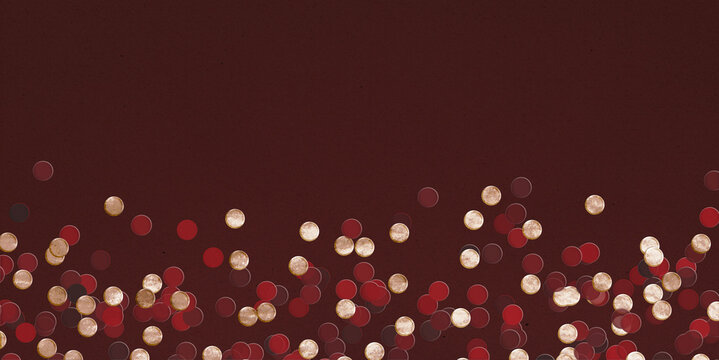 Red and gold confetti on dark, chocolate brown background