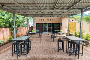 Chairs and tables in front of the minimarket