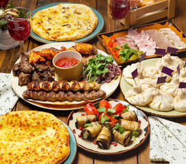 Georgian khinkali, meat shashlik, appetizers, a generous table of Georgian dishes. 