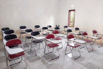 Desk chairs are arranged neatly in the classroom