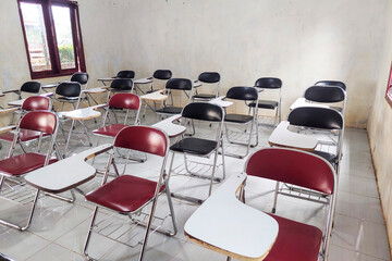 Desk chairs are arranged neatly in the classroom