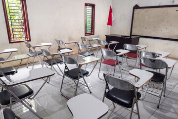 Desk chairs are arranged neatly in the classroom