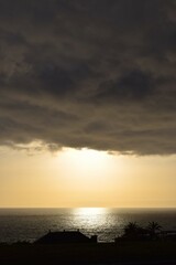 Beam of light as the sun sets behind the cloud on La Palma
