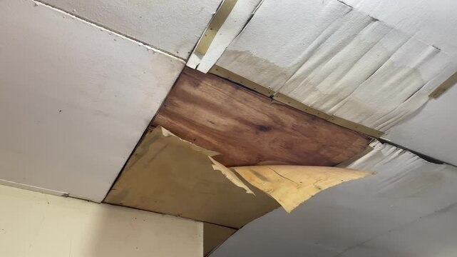 The house ceiling made of plywood peeled off due to rainwater. The house ceiling leaked. House The plywood ceiling peeled off