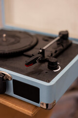 Close up of a vintage record player sitting on a table in a music studio.