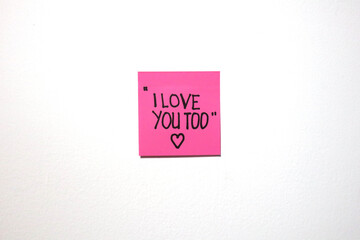 Love and motivational message on a sticky notes with isolated white background