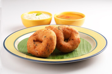 Medu Vada, a popular South Indian food served with Sambar ,Green coconut chutney ,Vada ,Medu vadai with sambar - Popular South Indian snack