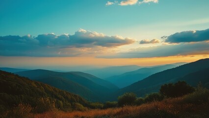 A breathtaking panoramic view of misty mountains at sunrise, showcasing layers of hills and lush greenery bathed in warm golden light