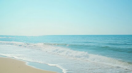 Obraz premium Clear blue ocean meeting white sands under a cloudless sky, inviting a peaceful beach atmosphere selective focus, pure relaxation, ethereal, Fusion, open shore backdrop
