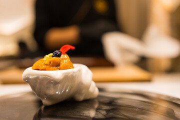 Luxury Japanese sea urchin in white mini bowl. Omakase Japanese food