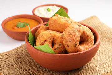 Medu Vada, a popular South Indian food served with Sambar ,Green coconut chutney ,Vada ,Medu vadai with sambar - Popular South Indian snack