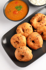 Medu Vada, a popular South Indian food served with Sambar ,Green coconut chutney ,Vada ,Medu vadai with sambar - Popular South Indian snack