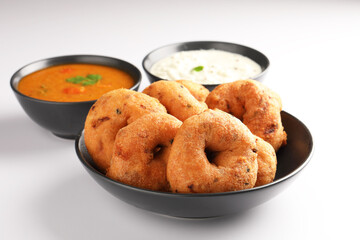 Medu Vada, a popular South Indian food served with Sambar ,Green coconut chutney ,Vada ,Medu vadai with sambar - Popular South Indian snack