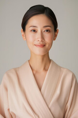 Elegant Japanese Lady Captured in Serene Beauty Portrait, Showcasing Gentle Sophistication with Warm Beige Tones in Neutral Studio Setting