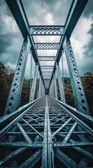  Dramatic angle of a truss bridge&rsquo;s joints with crisscrossing steel bars forming geometric patterns against overcast clouds.