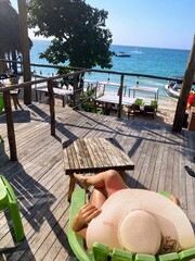woman sitting in front of the beach
