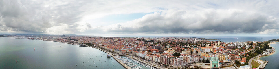 Panoramic aerial view of Santander city and port area. Panoramic view over promenade of the city. Turquoise water colour. Famous travel destination in North of Spain. Cloudy day. Aerial photography.