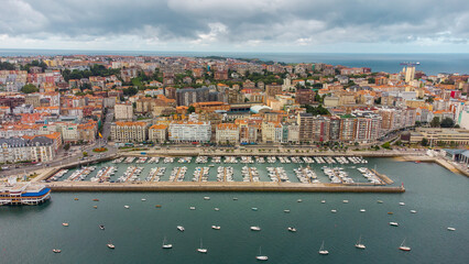 Spectacular aerial view of Santander Port. Panoramic view over promenade of the city. Turquoise water colour. Famous travel destination in North of Spain. Cloudy day. Aerial photography.