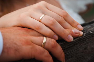 Holding wedding rings. Noble metal jewellery for married couples.Wedding ceremony and planing.Holding traditional bridal commitment jewellery.Golden ring for bride and groom.Marriage proposal exchange