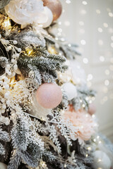 Festive Christmas tree adorned with ornaments and lights for New Year 2025