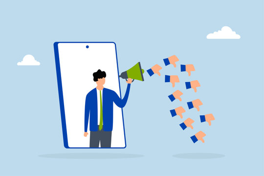 Internet hater, angry young man using megaphone while shouting from mobile phone with negative thumbs down icons. 