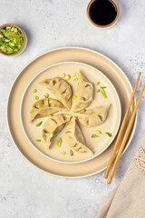 Food photography of vegetable gyoza dumplings, jiaozi, spring onion, soy sauce, steamed and stuffed dumplings, chopsticks, portion, vegetarian food, Chinese cuisine, Asian meal