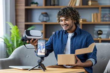 A man enthusiastically unboxes a virtual reality headset during a livestream. He is using a...