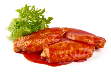 Marinated Buffalo chicken wings in red sauce with lettuce salad leaf, isolated on white background.