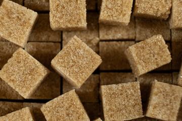 Cubes of brown cane unrefined demerara sugar.