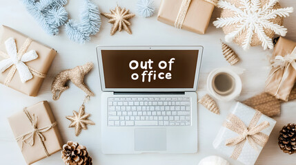 A laptop displaying an out of office message sits among holiday decorations, wrapped presents, and a festive coffee mug