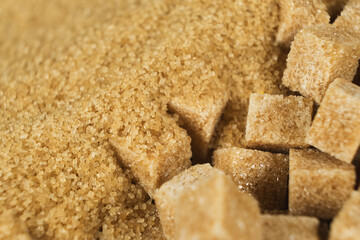 Brown cane unrefined demerara sugar in the form of crystals and cubes
