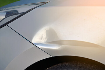 Dented car front fender, major collision on parking lot, accident damage and auto body repair...