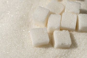 White refined beet sugar in the form of crystals and cubes.