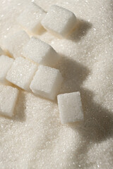 White refined beet sugar in the form of crystals and cubes.