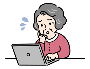 パソコンを見ながら困る高齢者女性