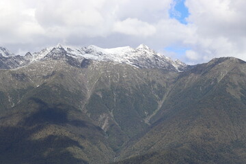 snow-capped mountain peaks in the clouds
