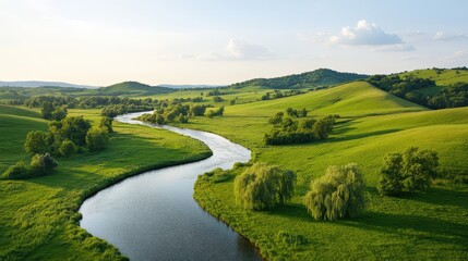Obraz premium Picturesque Countryside Scene of Rolling Hills and Serene River Flowing Through Lush Green Fields