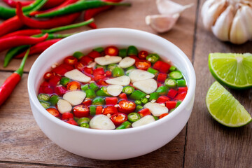 Chili with fish sauce in white bowl..