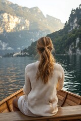Fototapeta premium A female traveller on a boat enjoy the beautiful scenery at a lake 