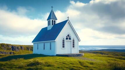Fototapeta premium White church on grassy cliff overlooking ocean under blue sky.