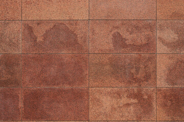 Granite tile wall, bricks, memorial cladding. Even rectangular red blocks, background. smooth...